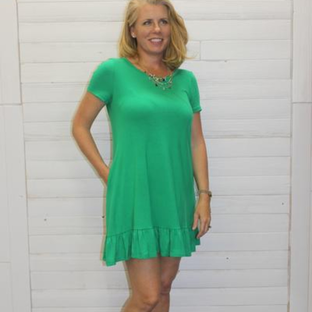 Green dress with ruffle hem and pockets